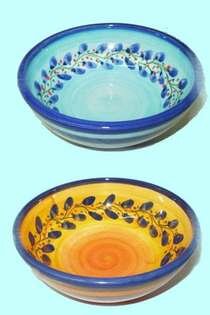 Two hand-painted Cretan bowls with olive branch patterns, one blue, one yellow